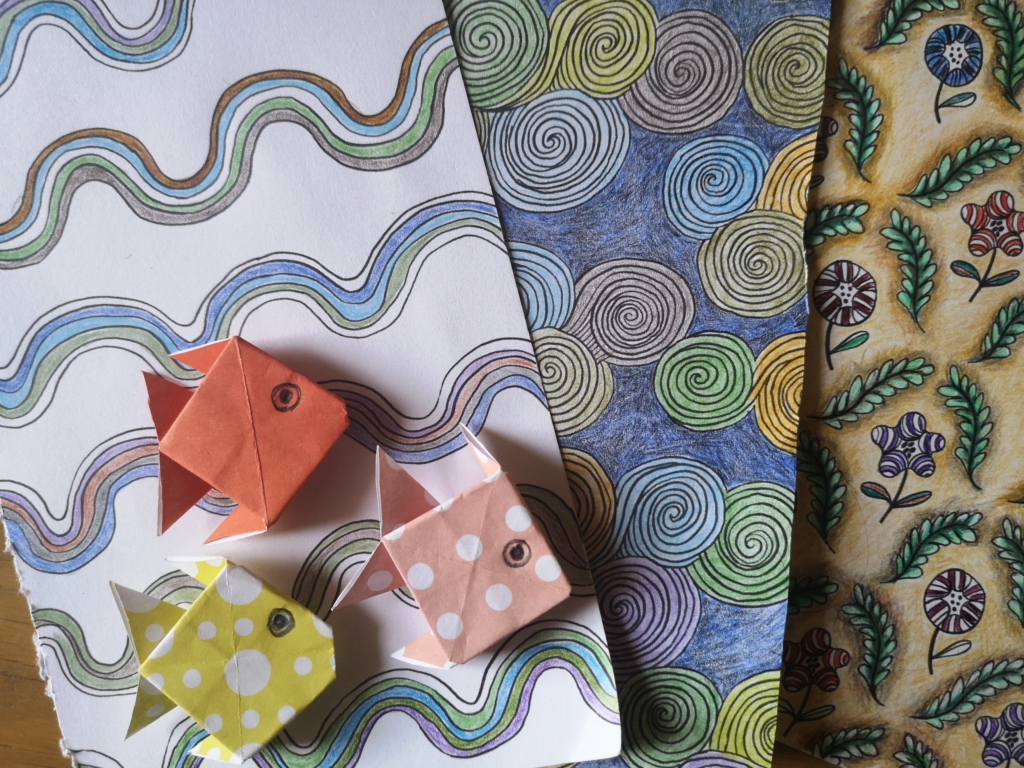 Using colouring books as a resource for greetings card - colouring book pages that would make a good background for a card, with simple origami motifs